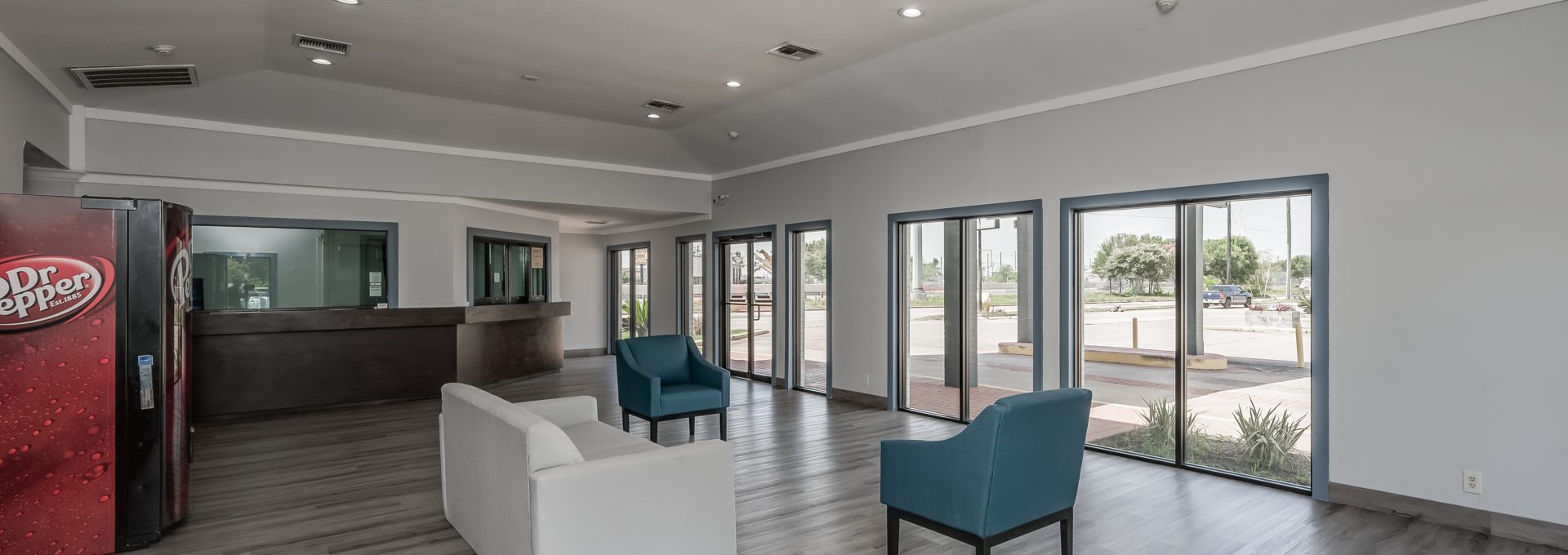 the lobby of a hotel with a large window at The  Studios At Channelview