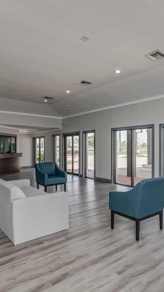 the lobby of a hotel with a large window at The  Studios At Channelview