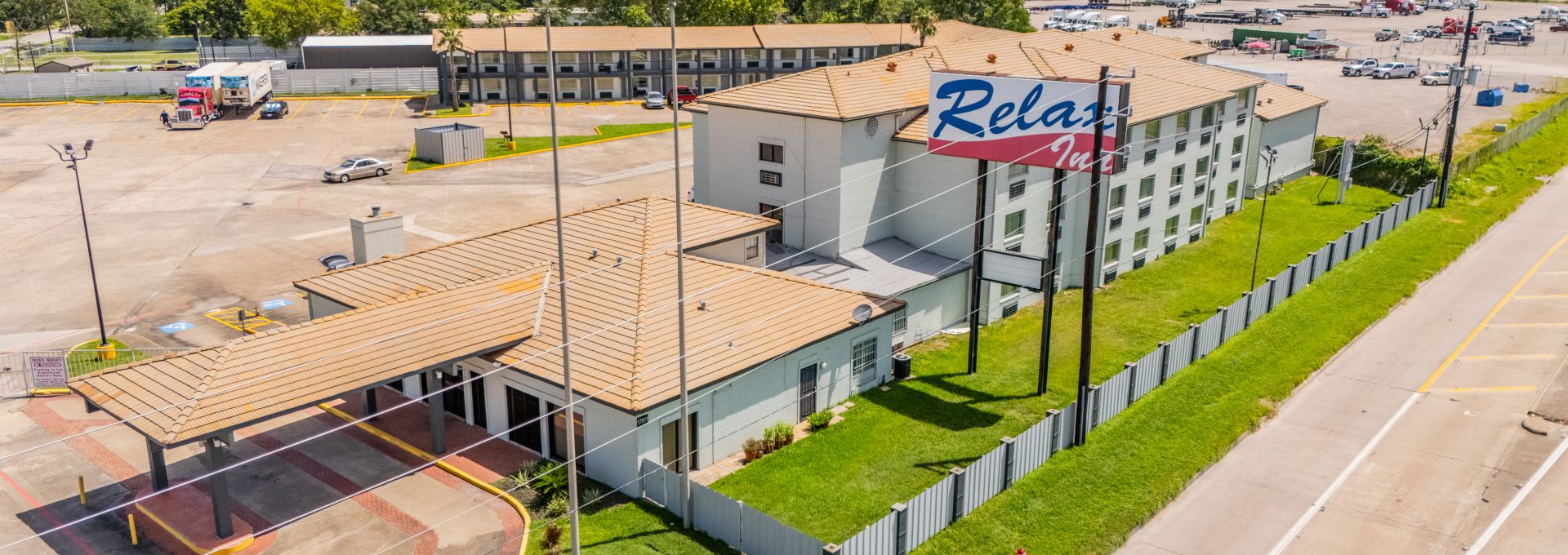 an aerial view of a motel with a parking lot at The  Studios At Channelview