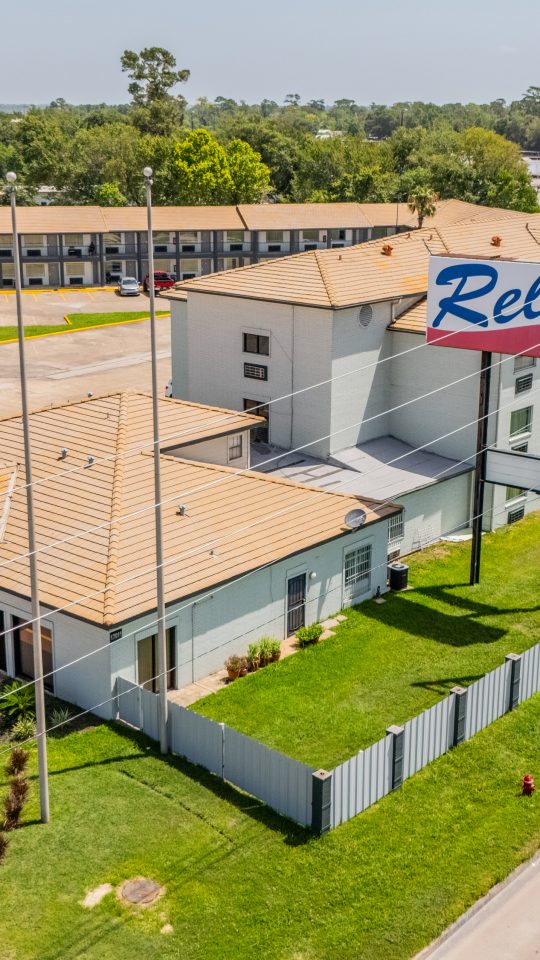 an aerial view of a motel with a parking lot at The  Studios At Channelview